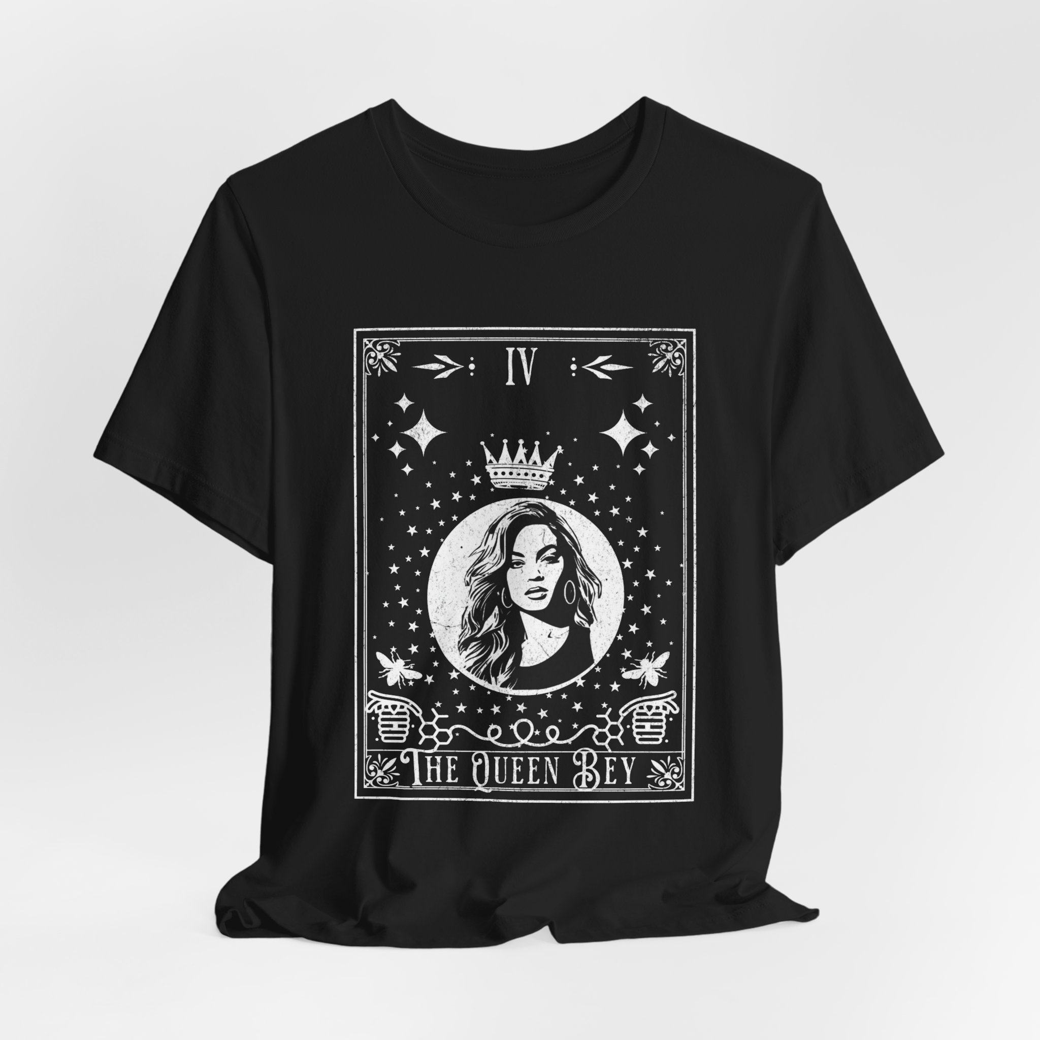 Black and white unisex T-shirt featuring a bold graphic design that reads "The Queen Bey," celebrating Beyoncé. The shirt is displayed on a neutral background, showcasing its soft fabric and classic crew neck style.